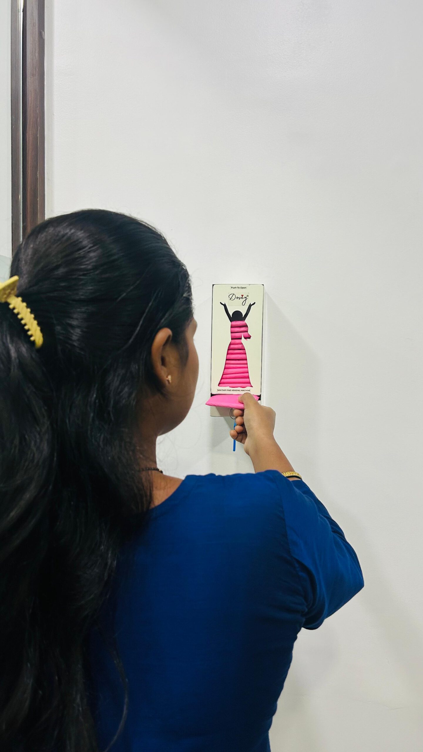A woman using a Dovey vending machine